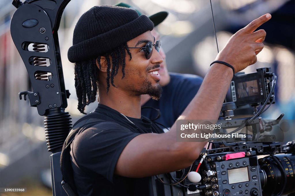 Camera operator smiles while filming