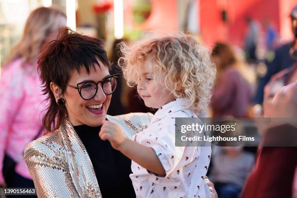 mother smiles at son at the fair - fete bildbanksfoton och bilder