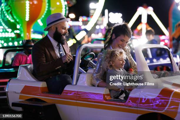 family rides trucks at carnival - modern boy hipster stock-fotos und bilder