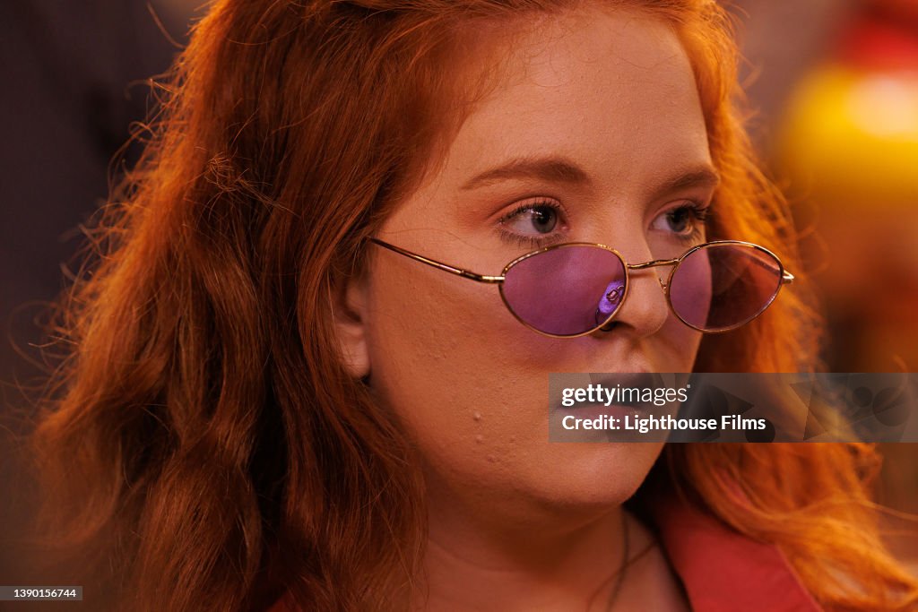 CU. Portrait of red-haired young woman