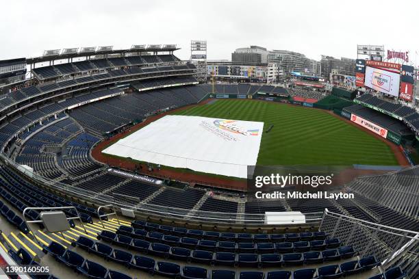 General view of the field covered with the rain tarp before the game between the New York Mets and the Washington Nationals on Opening Day at the...