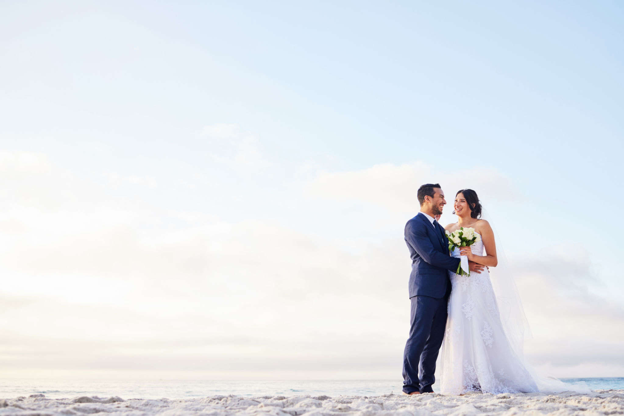 Shot of a young couple on the beach on their wedding day Shot of a young couple on the beach on their wedding day