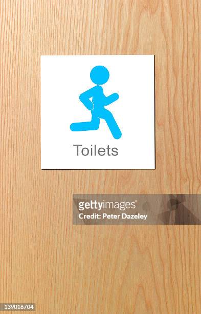 sign showing desperate man running for toilet - human representation stock pictures, royalty-free photos & images