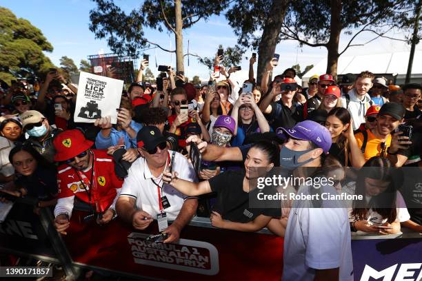 Daniel Ricciardo of Australia and McLaren arrives at the circuit and poses for a photo with a fan prior to practice ahead of the F1 Grand Prix of...