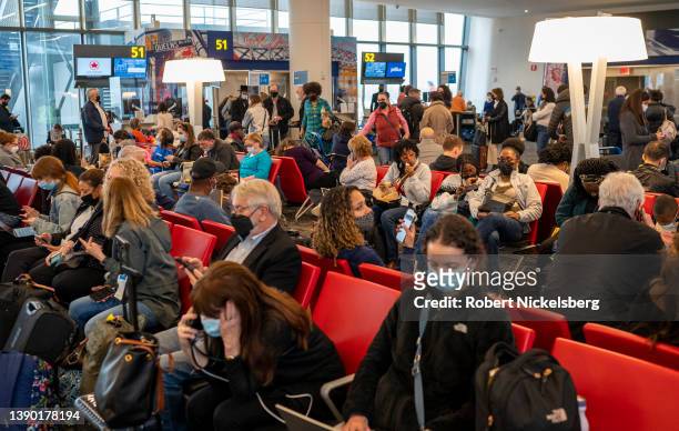 JetBlue Airways passengers wait for their departing flights April 7, 2022 in the newly designed LaGuardia Airport in New York City.