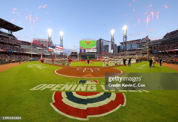 Players stand during the National Anthem prior to the opening day game between the Atlanta Braves and the Cincinnati Reds at Truist Park on April 07,...