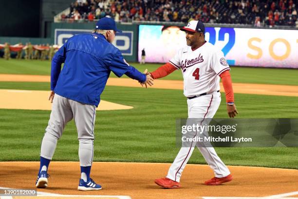 Managers Buck Showalter of the New York Mets and Dave Martinez of the Washington Nationals shake hands before a baseball game on Opening Day at the...