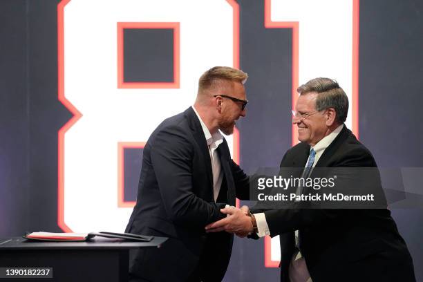 Former Chicago Blackhawks player Marian Hossa shakes hands with Blackhawks Chairman Rocky Wirtz after signing a one day contract to retire as a...