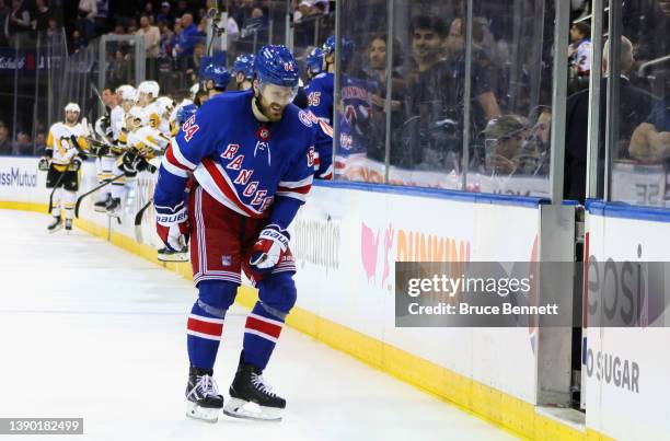 Tyler Motte of the New York Rangers leaves the ice following a hit from Anthony Angello of the Pittsburgh Penguins during the third period at Madison...