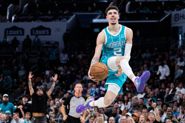 LaMelo Ball of the Charlotte Hornets lobs up the ball for an alley-oop in the fourth quarter during their game against the Orlando Magic at Spectrum...