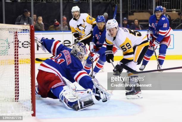 Igor Shesterkin of the New York Rangers makes a third period save on Jake Guentzel of the Pittsburgh Penguins at Madison Square Garden on April 07,...