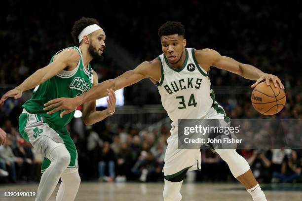 Giannis Antetokounmpo of the Milwaukee Bucks drives past Derrick White of the Boston Celtics during the second half at Fiserv Forum on April 07, 2022...