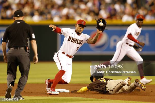 Infielder Ketel Marte of the Arizona Diamondbacks catches the ball as Ha-Seong Kim of the San Diego Padres steals second base during the third inning...