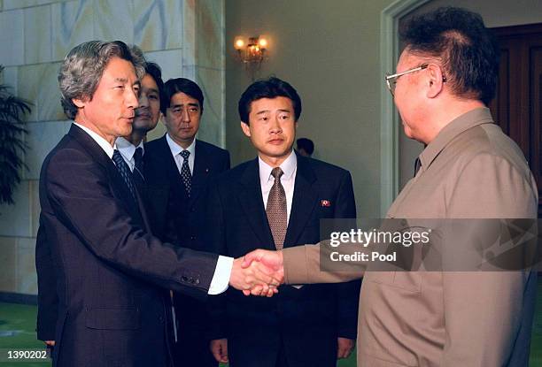 Japanese Prime Minister Junichiro Koizumi shakes hands with North Korean leader Kim Jong-il prior to their summit talks at the Paekhwawon state...