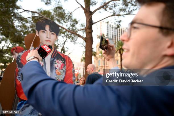 New reporter pretends to interview a cardboard cutout of BTS band member Jungkook along the Las Vegas Strip on April 07, 2022 in Las Vegas, Nevada....