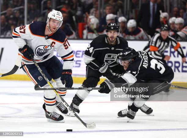 Connor McDavid of the Edmonton Oilers skates with the puck past Viktor Arvidsson and Phillip Danault of the Los Angeles Kings during a 3-2 Oilers win...