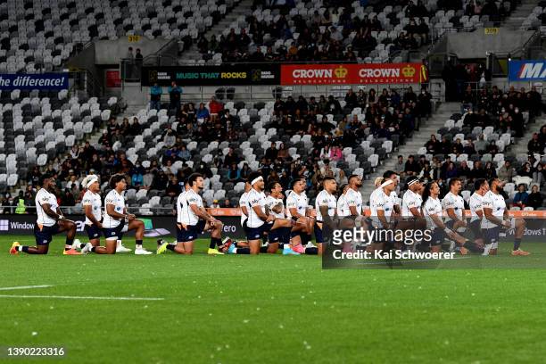 Moana Pasifika take a knee as the Highlanders perform a haka during the round eight Super Rugby Pacific match between the Highlanders and the Moana...
