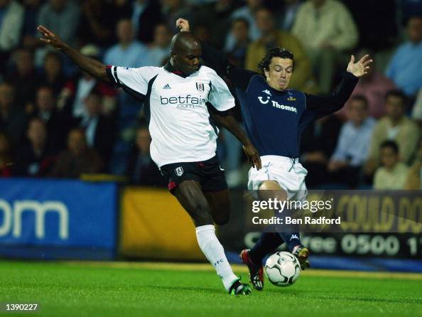 Pierre Wome of Fulham and Simon Davies of Tottenham Hotspur Pierre Wome of Fulham and Simon Davies of Tottenham Hotspur