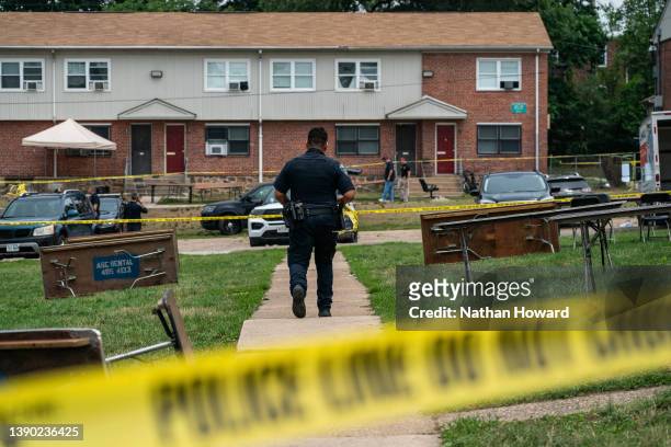 Baltimore Police investigate the site of a mass shooting in the Brooklyn Homes neighborhood on July 2, 2023 in Baltimore, Maryland. At least two...