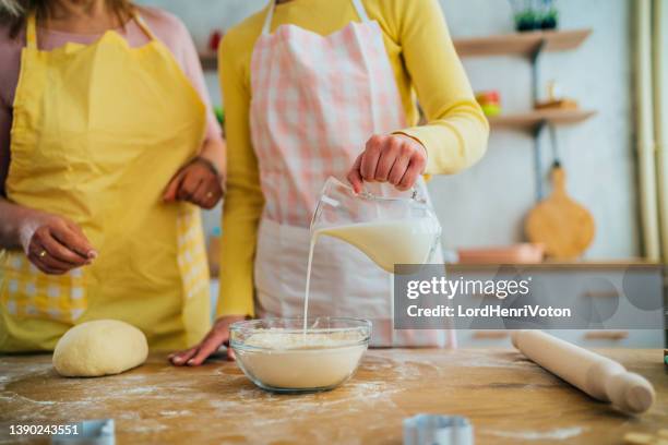 mother and daughter preparing dough - milk jug stock pictures, royalty-free photos & images