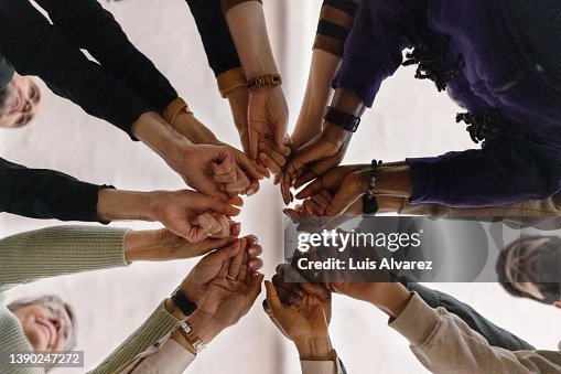 People with fist put together during support group session People with fist put together during support group session