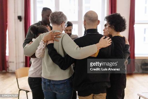 support group  standing in a huddle - briefing stockfoto's en -beelden