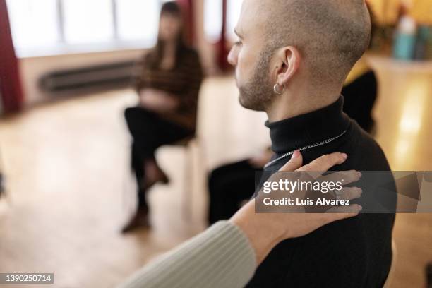 emotional man sharing his story during a support session - addiction recovery foto e immagini stock