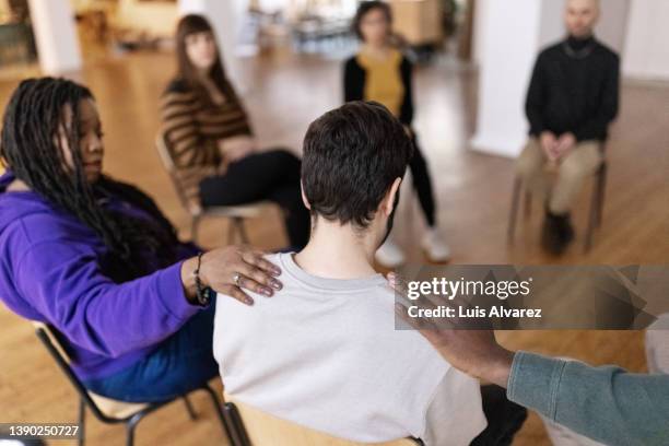 group of people sitting in circle during support group meeting - phobia foto e immagini stock