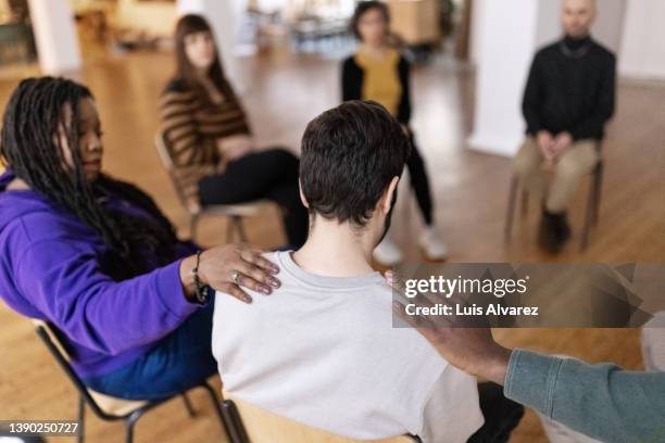 group of people sitting in circle during support group meeting - phobia imagens e fotografias de stock