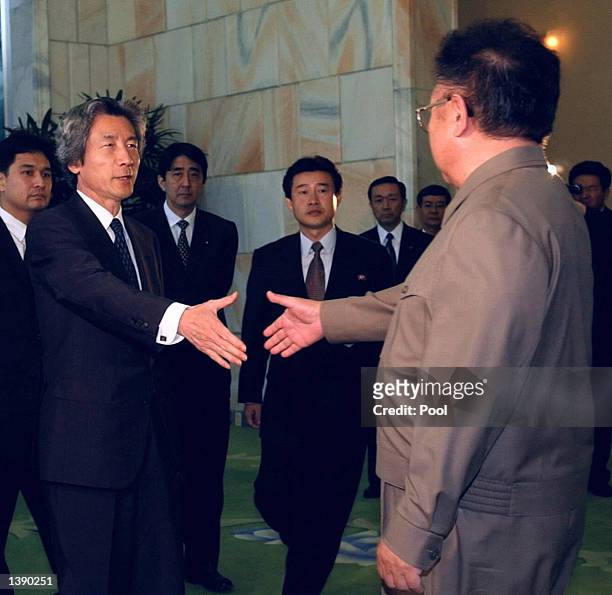 Japanese Prime Minister Junichiro Koizumi shakes hands with North Korean leader Kim Jong-il prior to their summit talks at the Paekhwawon state...