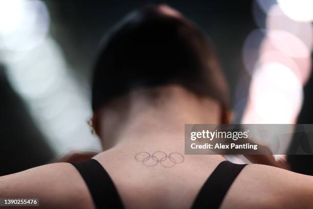 Detailed view of the Olympic rings tattooed onto the neck of Freya Anderson of Team Bath NC before she competes in the Women's 100m freestyle heats...