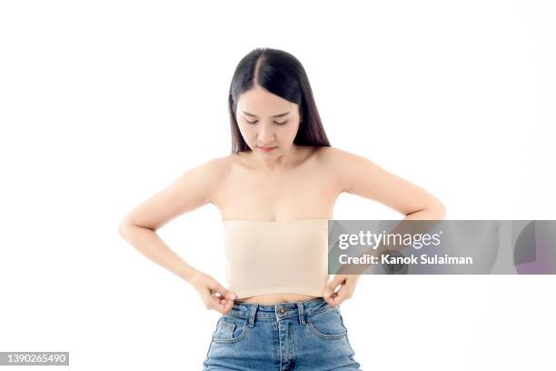 young woman losing weight - woman waist up isolated stock pictures, royalty-free photos & images