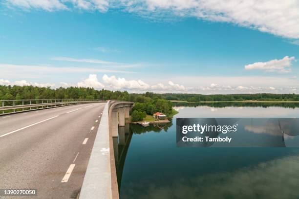 sweden, loftahammar, empty coastal road and calm sea sky - kalmar foto e immagini stock