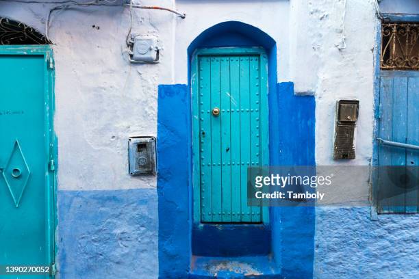 morocco, chefchaouen, doors of traditional blue house - chefchaouen medina stock pictures, royalty-free photos & images