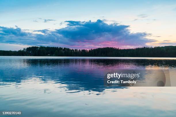 lake reflecting clouds at sunset - kalmar bildbanksfoton och bilder