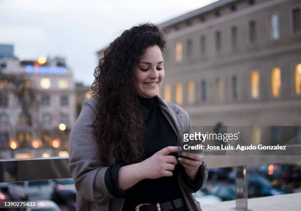female texting on cellphone on bridge - send bildbanksfoton och bilder