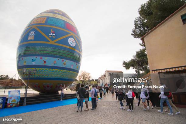 Several people photograph the world's largest decorated Easter egg, recognized by Guinness World Records, at the presentation of the park's 2022...