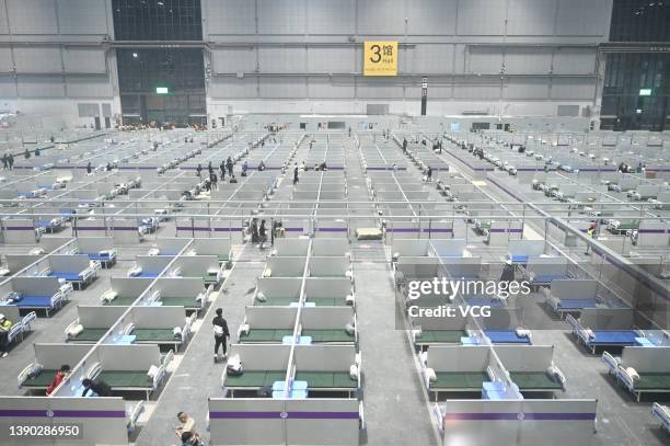 Workers set up a makeshift hospital for Covid-19 patients at the National Exhibition and Convention Center on April 8, 2022 in Shanghai, China. The...