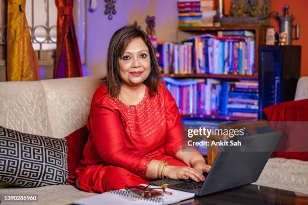 woman working on laptop at home - india economy business and finance stock pictures, royalty-free photos & images