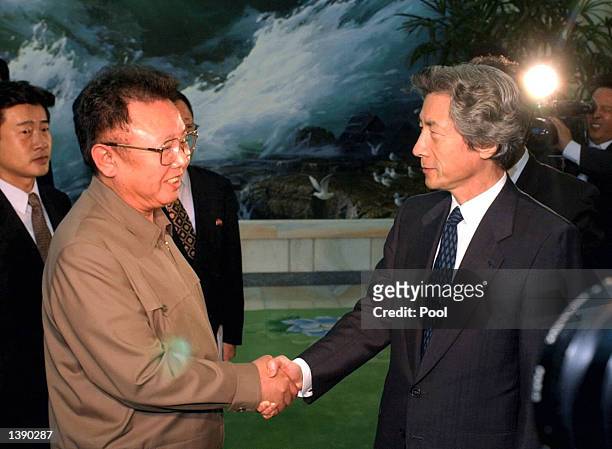Japanese Prime Minister Junichiro Koizumi shakes hands with North Korean leader Kim Jong-il after their summit talks at the Paekhwawon state...