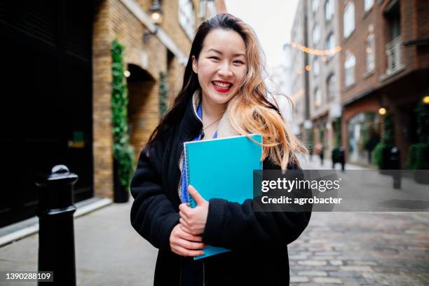 happy female asian student in london - campus tour stock pictures, royalty-free photos & images