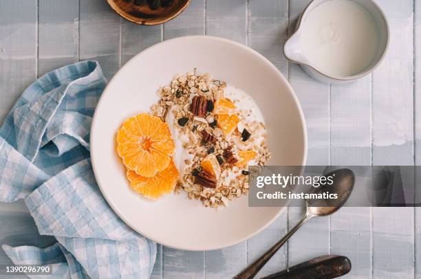 haferflocken mit joghurt und mandarine - haferflocken stock-fotos und bilder