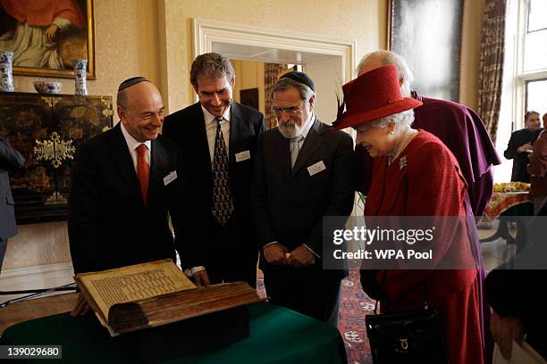 Britain's Queen Elizabeth II is shown the Codex Valmadonna I book by Jewish guests, from left, President of Board of Deputies of British Jews, Vivian...