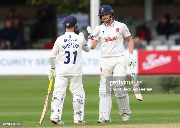 Matt Critchley of Essex celebrates scoring a half century with Adam Wheater of Essex during Day Two the LV= Insurance County Championship match...