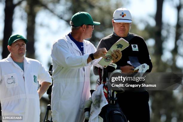 Sungjae Im of South Korea and caddie William Spencer line up a shot from the fourth tee during the second round of The Masters at Augusta National...