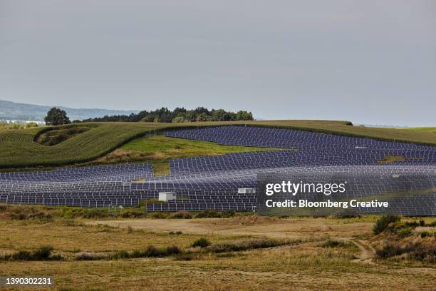 solar panels on a hillside - economy rural in poland stockfoto's en -beelden