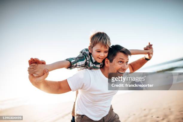 glücklicher vater umarmt den sohn - flying dad son stock-fotos und bilder