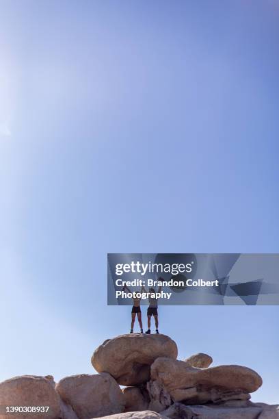 young couple hike rocks - love on the rocks stock pictures, royalty-free photos & images