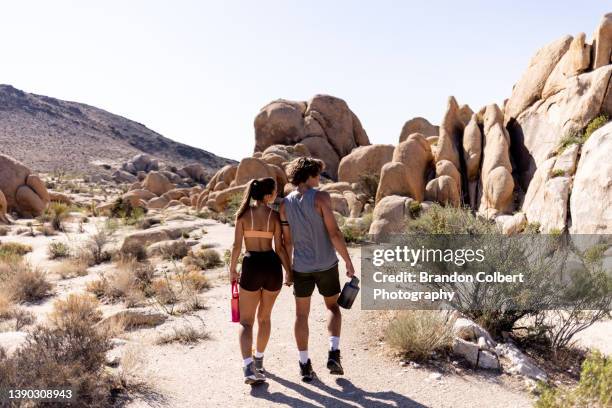 young couple hiking - joshua tree bildbanksfoton och bilder