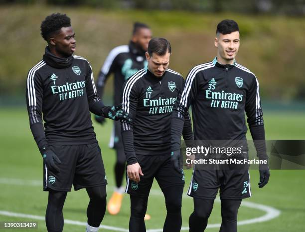 Bukayo Saka, Cedric and Gabriel Martinelli of Arsenal during a training at London Colney on April 08, 2022 in St Albans, England.